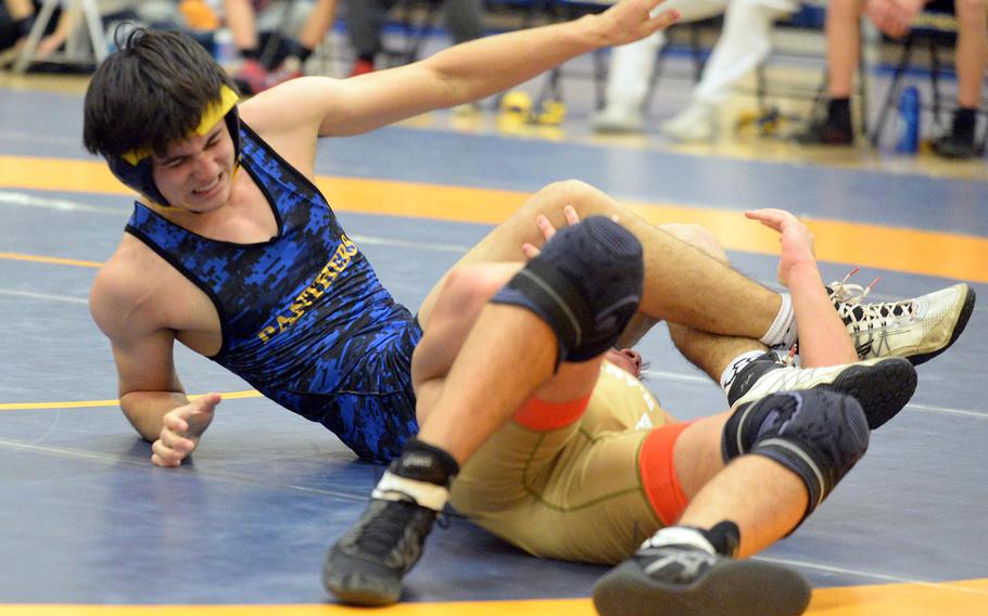 Yokota 160-pounder Kaiyo Heinrichs grimaces as he gets rolled in a leg lace by St. Mary's Luke Yamada during Wednesday's Kanto Plain dual meet. Yamada won by technical fall 12-1 in 2 minutes, 55 seconds, and the Titans won the meet 40-18.