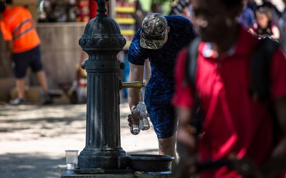 A visitor refills water bottles at a drinking fountain at Ciutadella Park, a designated climatic refuge, part of Barcelona's Climate Shelter Network (CSN), where residents can take shelter during extreme heat, in Barcelona. MUST CREDIT: Bloomberg photo by Angel Garcia