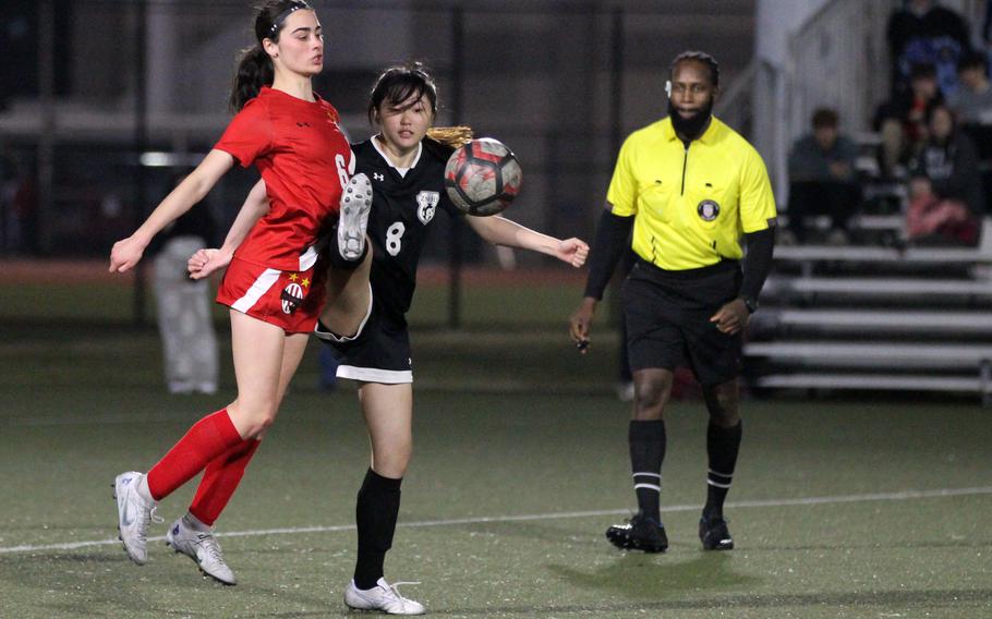 Nile C. Kinnick’s Julia Angelinas and Zama‘s Sarah Larm try to settle the ball during Friday’s DODEA-Japan girls soccer match. The Red Devils won 8-0.