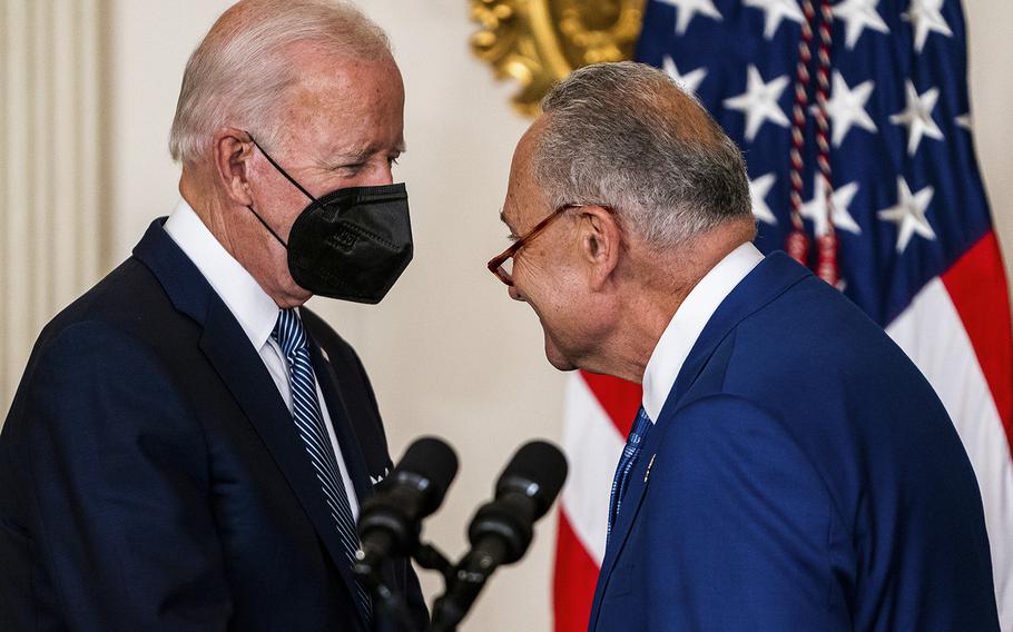 President Biden and Senate Majority Leader Chuck Schumer, D-N.Y., greet one another before Biden signed the Inflation Reduction Act into law. 