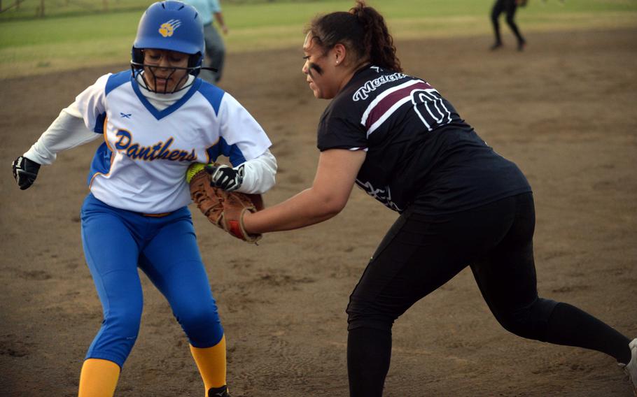 Zama third baseman Deborah McClendon tries to tag Yokota baserunner Kiara Aponte Ortiz during Tuesday’s DODEA-Japan softball game. The ball came loose and Aponte Ortiz was called safe. The Panthers won 15-3.