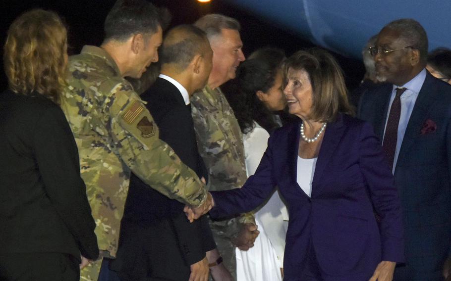 U.S. House Speaker Nancy Pelosi greets 374th Airlift Wing commander Col. Andrew Roddan upon her arrival at Yokota Air Base, Japan, Thursday, Aug. 4, 2022. 