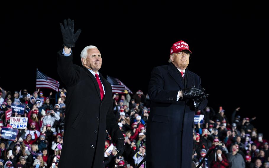 Then-Vice President Mike Pence waves to the crowd during a Michigan campaign rally with then-President Donald Trump in November 2020.
