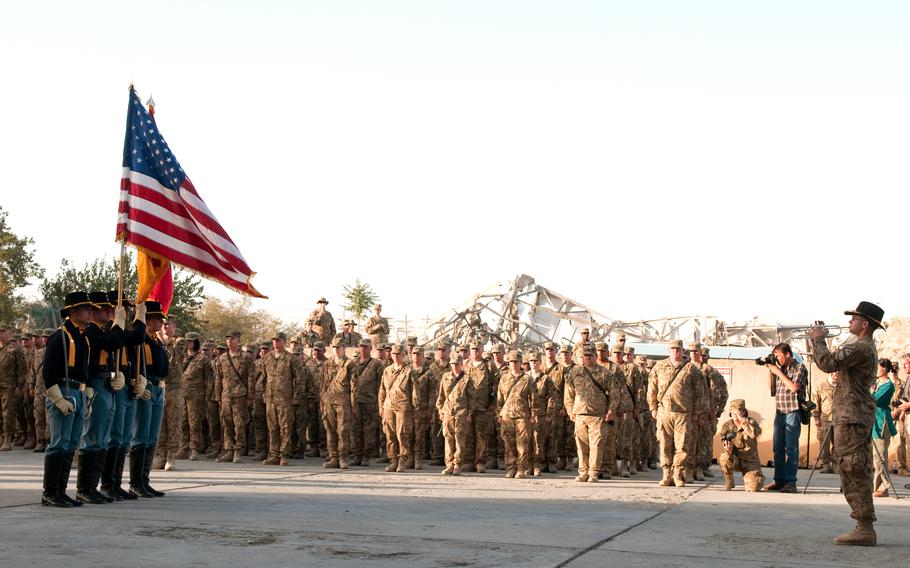 A 1st Cavalry Division bugler relays commands to the color guard during a ceremony in Bagram Airfield, Afghanistan, Sept. 11, 2011, remembering the attacks of 9/11. 