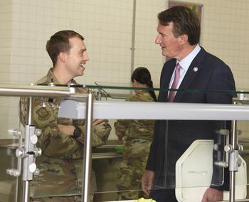 Virginia Gov. Glenn Youngkin chats with Air Force Capt. Randolph Carey, of Arlington, Va., at the Samurai Cafe on Yokota Air Base, Japan, Wednesday, April 26, 2023. 