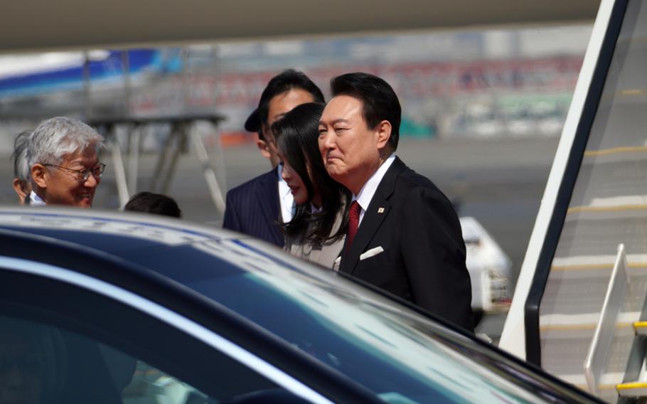 South Korean President Yoon Suk Yeol arrives at Haneda International Airport in Tokyo with his wife, Kim Keon-hee, March 16, 2023.