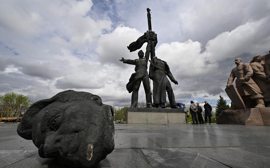 Workers dismantle the Soviet monument to Ukraine-Russia friendship in Kyiv on April 26, 2022, amid the Russian invasion of Ukraine.