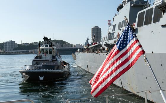 Tugboats guide the guided-missile destroyer USS Higgins to a berth at Yokosuka Naval Base, Japan, Oct. 13, 2023. 