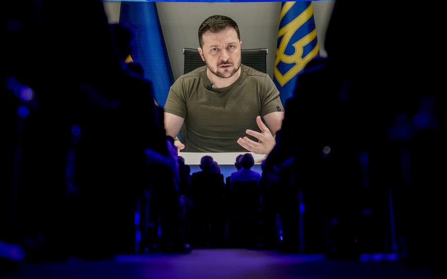 Ukraine President Volodymyr Zelenskyy addresses the audience from Kyiv on a screen during the World Economic Forum in Davos, Switzerland, Monday, May 23, 2022. 