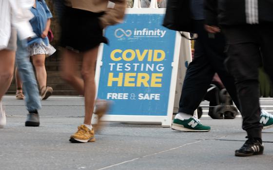 People walk past a COVID-19 testing site on May 17, 2022, in New York. (Spencer Platt/Getty Images/TNS)