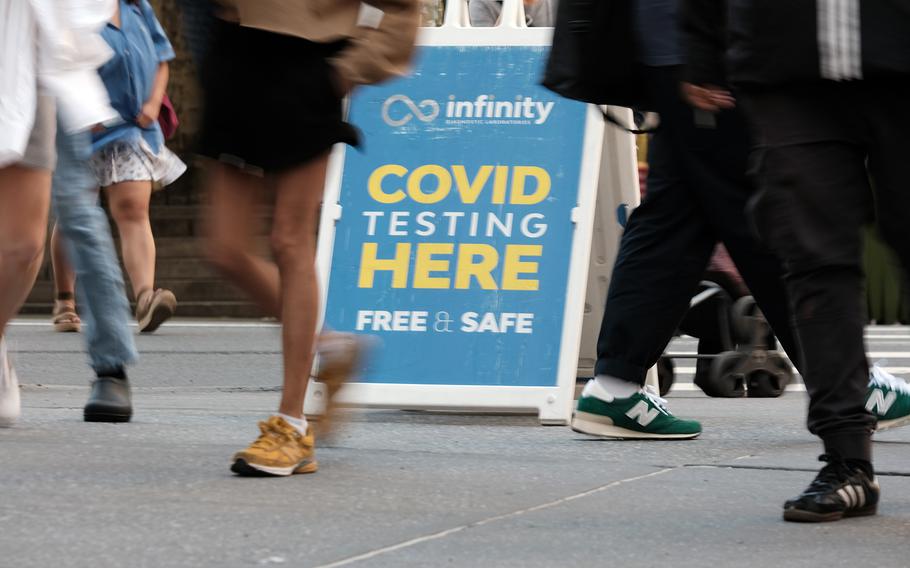 People walk past a COVID-19 testing site on May 17, 2022, in New York. 