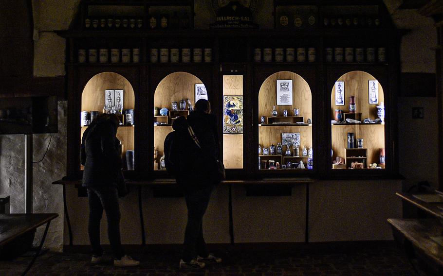 Visitors look at the display of "materia medica," or raw materials that are either medicines themselves or can be processed into them, at the German Pharmacy Museum in Heidelberg, Germany. The museum holds the world's largest stock of such materials of the 17th to 20th centuries.