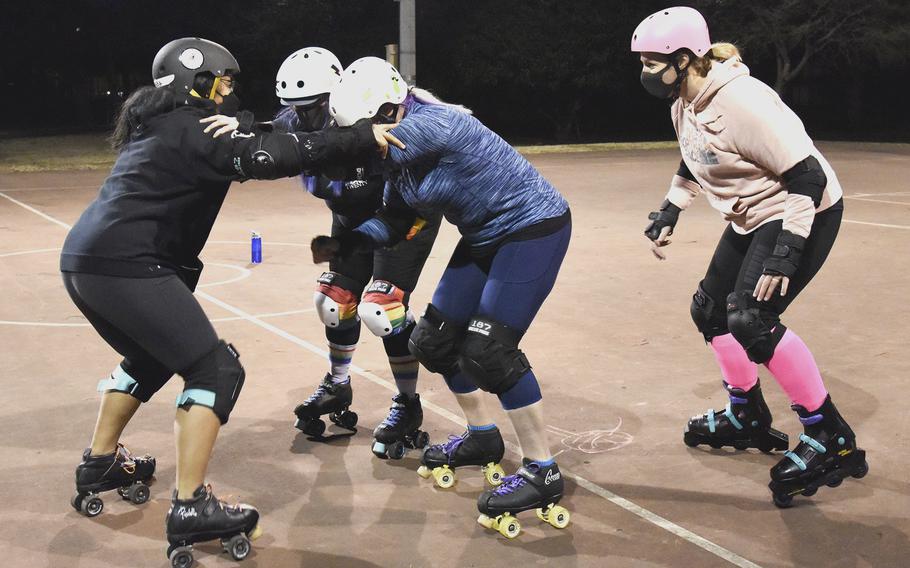 Fuji Flatliners practice roller derby skills at a basketball court at Yokota Air Base, Japan, on Feb. 28, 2022. 