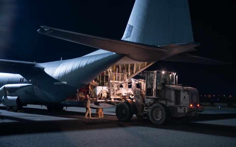 U.S. Air Force loadmasters and aerial porters load a buffer stop assembly onto a C-130J Super Hercules prior to loading pallets of humanitarian aid destined for Gaza at an undisclosed location within the U.S. Central Command area of responsibility, Tuesday, March 5, 2024. 