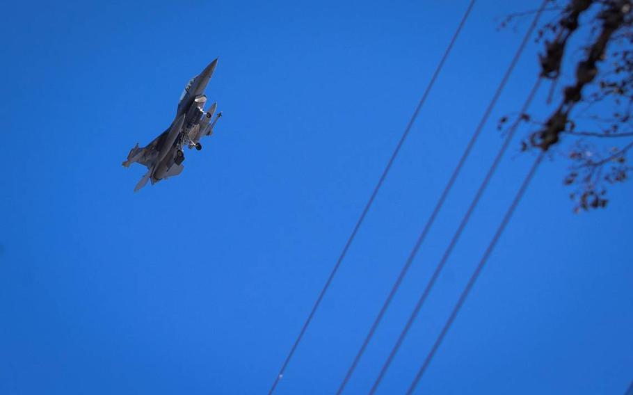 A military jet flies over homes along Caddo Trail in an area designated as Accident Potential Zone I in October in Lake Worth. The Department of Defense recommends no housing in that type of zone.