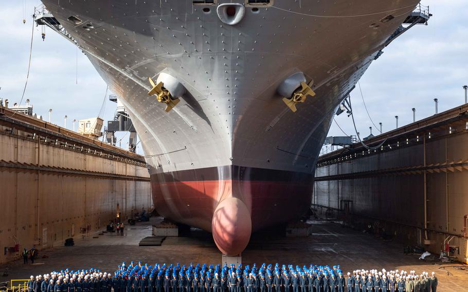 The crew gathers below amphibious assault ship USS Essex in the Pride of California Dry Dock in San Diego, Sept. 6, 2023. Secretary of the Navy Carlos Del Toro has ordered that service members assigned to ships in dry dock may refuse nonjudicial punishment and ask for a court-martial.  