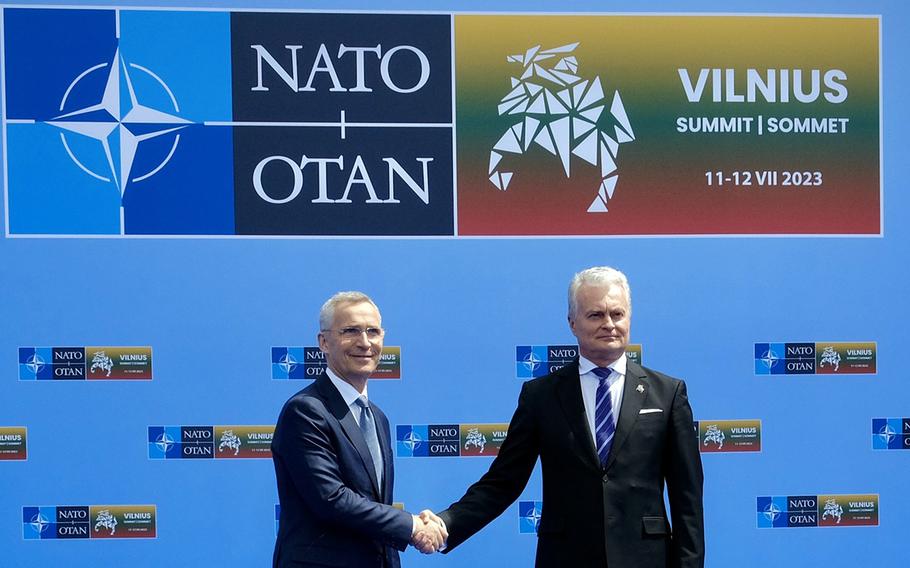 NATO Secretary-General Jens Stoltenberg, left, and Lithuanian President Gitanas Nauseda shake hands before a July 10, 2023 meeting in Vilnius, Lithuania, ahead of the NATO summit that starts tomorrow. At a news conference, the pair spoke about Ukraine’s eventual path into NATO, which is to be discussed at the summit.