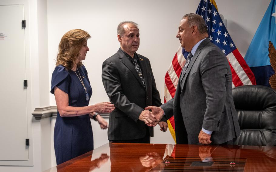 Pentagon official Gilbert Cisneros, right, shakes hands with Patrick and Teri Caserta, parents of Brandon Caserta, on May 5, 2023. Brandon Caserta’s suicide prompted his parents to seek congressional legislation making it easier for service members to seek mental health services.
