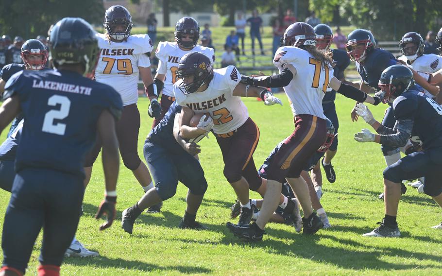 Vilseck’s Maverick Chase plows his way through a sea of Lakenheath defenders during the first half of their football game on Friday, Sept. 15 in Vilseck, Germany.