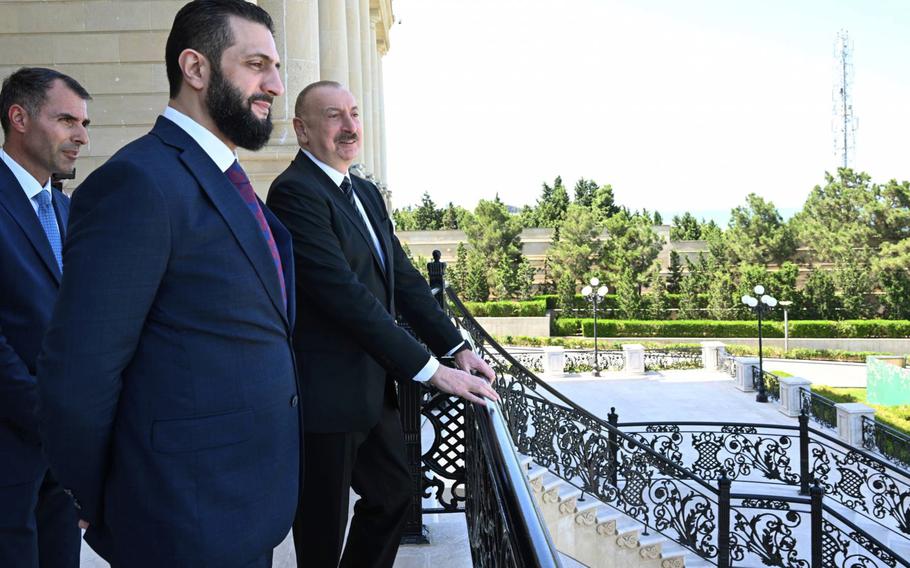  Azerbaijani President Ilham Aliyev, right, stands with Syria’s interim president, Ahmad al-Sharaa.