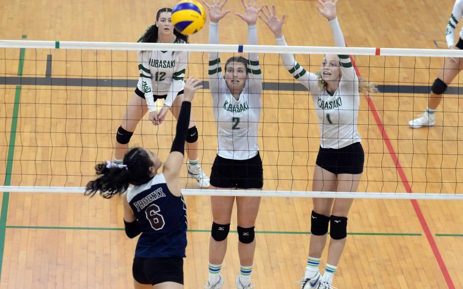 Seisen's Ann Katashiba spikes against Kubasaki's Grace Berrens and Emma Leggio.