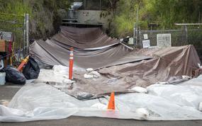 Tarps cover the spill site of PFAS-infused firefighting foam concentrate at an entrance to the Red Hill Bulk Fuel Storage Facility in Honolulu, Dec. 9, 2022.