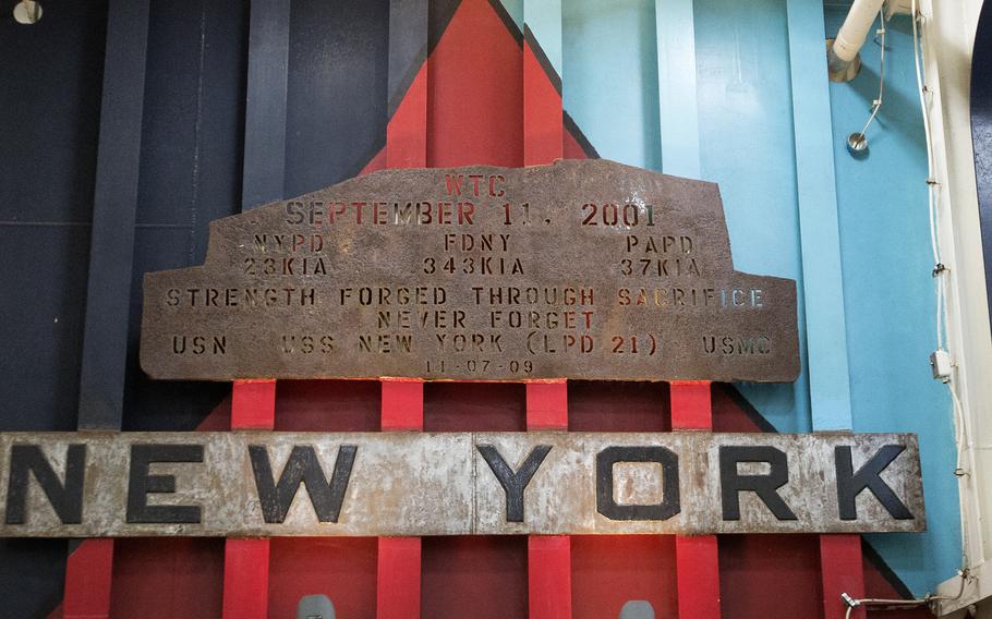 A piece of rusted steel from the World Trade Center, inscribed in remembrance of those killed, hangs over the vehicle ramp on the USS New York, an amphibious transport dock ship, at Naval Station Norfolk Sunday afternoon, Nov. 5, 2023.