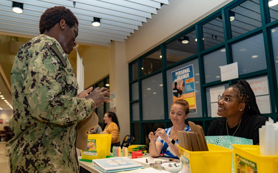 Navy personnel assigned to Naval Forces Central Command speak at a mental health awareness event in Bahrain on April 12, 2023. Service members deployed to Bahrain are taking part in a two-day stand-down as part of the service's effort to increase awareness of and access to mental health care at the base.