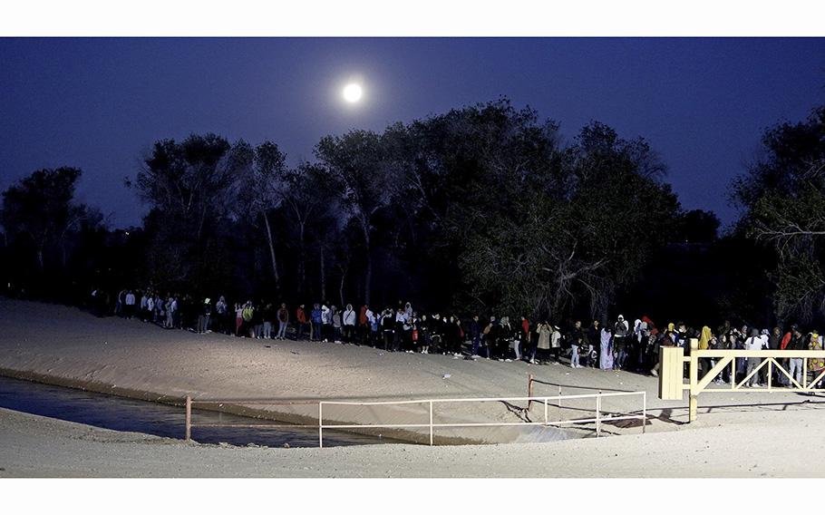 Asylum seekers are able to cross the border unimpeded near the Cocopah Indian Reservation to wait for Border Patrol officers to take them for processing in Yuma, Arizona.