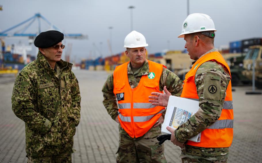 Portuguese army Maj. Gen. Joao Paulo de Almeida, left, talks with Col. Robert Kellam, center, the 598th Transportation Brigade commander, and Lt. Col. Michael Harrell, the 839th Transportation Battalion commander, during an operation Dec. 7, 2023, at the port of Setubal in Portugal.