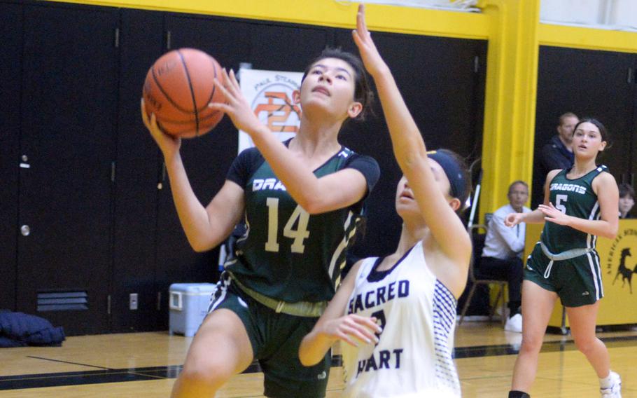 Kubasaki's Jessica Blackston drives to the basket against International School of the Sacred Heart. The Dragons won 35-13.