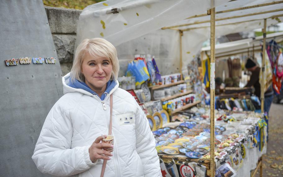 Tetiana Zhornova operates a souvenir cart on Volodymyrska Street, one of the oldest boulevards in Kyiv, Ukraine, on Oct. 27, 2022. Zhornova said she feels safer outdoors by her cart than in her home, where Russian missile attacks on her neighborhood have left cracks in her recently wallpapered apartment wall.