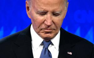 A close-up picture of former President Joe Biden against a bright blue background. 