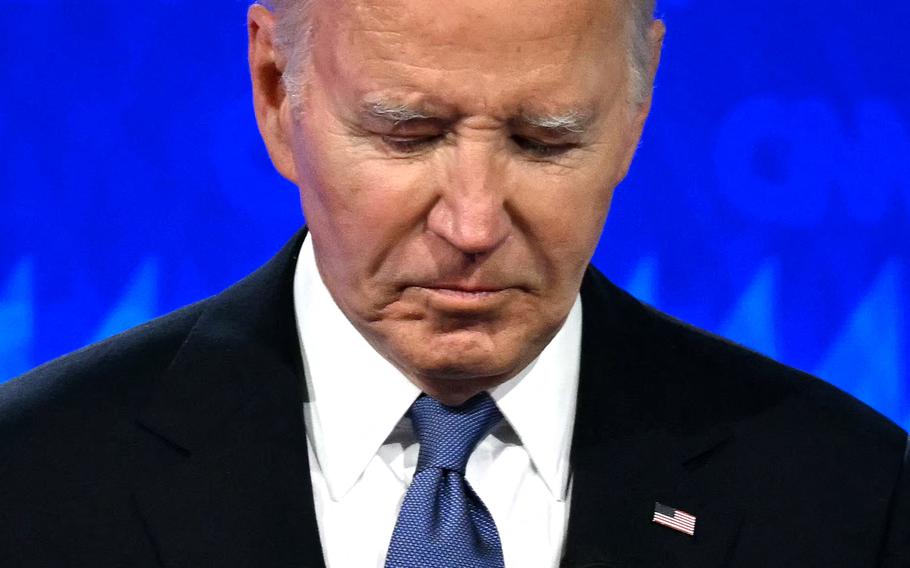 A close-up picture of former President Joe Biden against a bright blue background. 