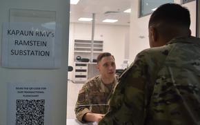 A uniformed troop mans a customer service window.