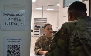 A uniformed troop mans a customer service window.