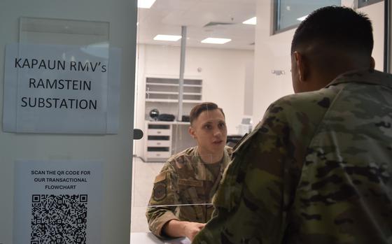 A uniformed troop mans a customer service window.