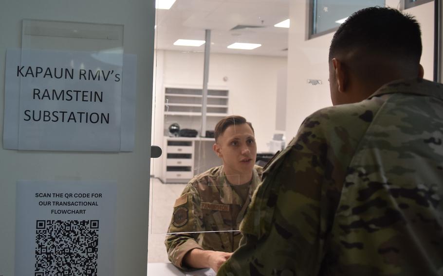A uniformed service member staffs a customer service window.