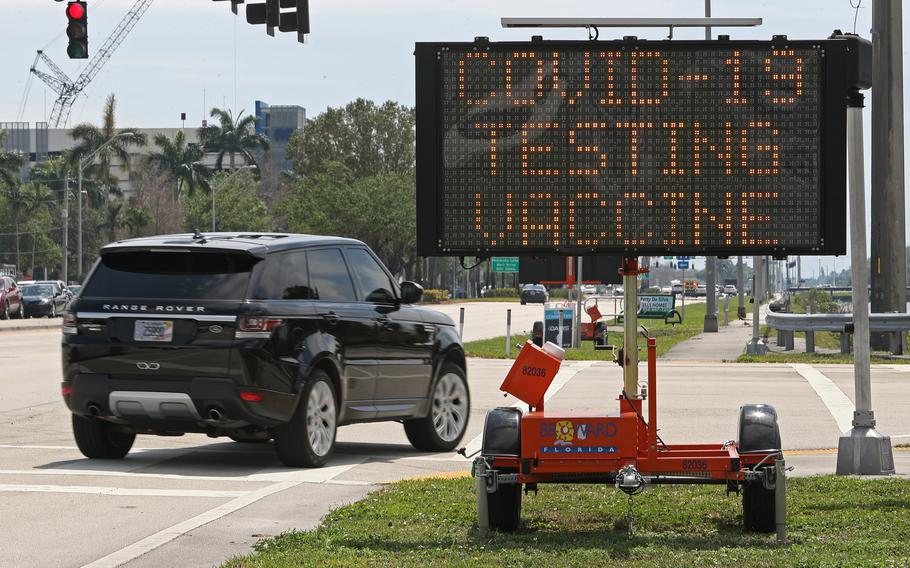 A sign alerts drivers to the COVID-19 testing and vaccination site at C.B. Smith Park on March 25, 2022, in Pembroke Pines, Fla. 