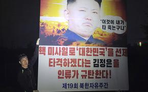 Park Sang-hak, a North Korean defector-turned-activist, holds a placard condemning North Korean leader Kim Jong Un in the border town of Paju, South Korea, Saturday, Oct. 1, 2022.