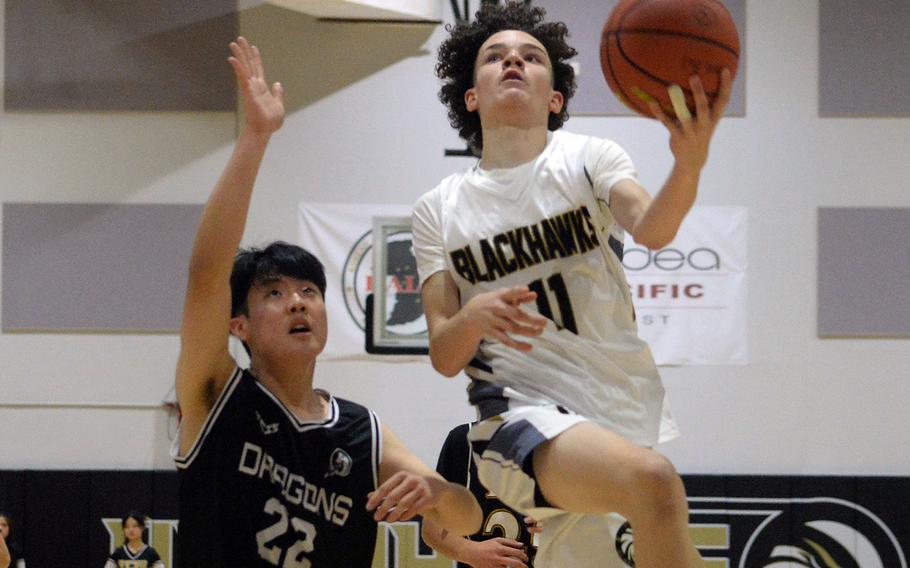 Humphreys' Elijah Kidd drives to the basket against Taejon Christian during Wednesday's Korea boys basketall game. The Blackhawks won 93-70.