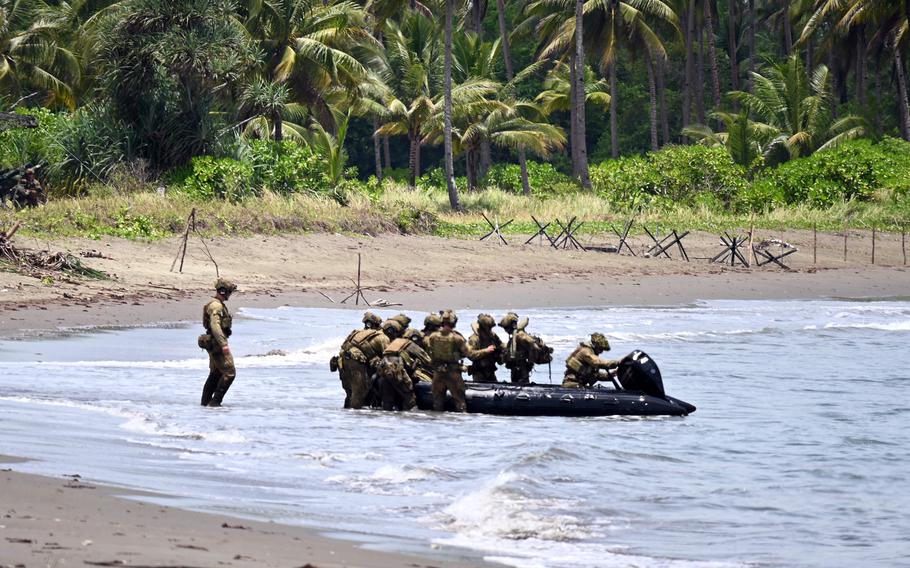 Australian soldiers, armed with a Javelin missile launcher, deploy in an inflatable boat. 