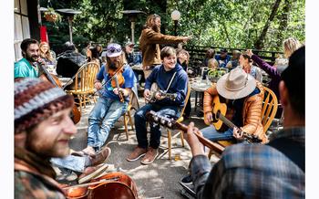 Nicholas Leahy, center, plays with other musicians at Pfeiffer State Park on April 6, 2024. Community gatherings, with free pizza, are one way Big Sur residents are coping with the closure of Highway 1. 