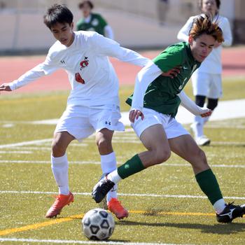 E.J. King’s Alex Lachica and Kubasaki’s Cody Wong tangle for the ball during Friday’s Dragons’ 3-1 Perry Cup win over the Cobras.