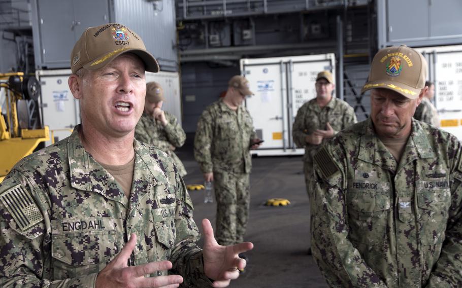 The commander of Expeditionary Strike Group 7, Rear Adm. Chris Engdahl, left, and the USS Miguel Keith's skipper, Capt. Troy Fendrick, speak to reporters from the ship's mission deck at White Beach Naval Facility, Okinawa, Oct. 6, 2021. 