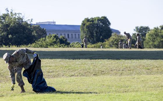 National Guardsmen pick up debris Tuesday, Aug. 26, 2025 in Washington at the Washington Monument. (Eric Kayne/Stars and Stripes)