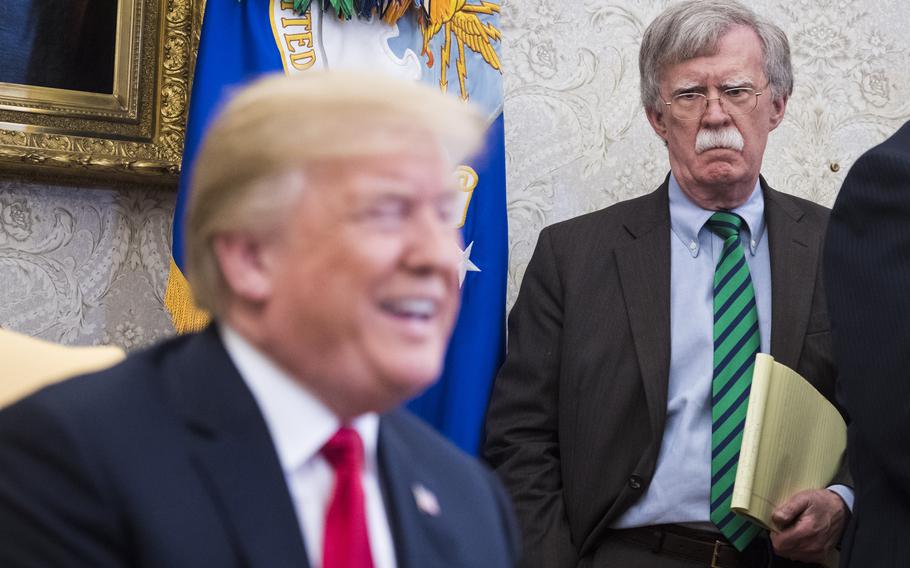 Bolton listens as Trump speaks with Stoltenberg during a meeting in the Oval Office at the White House in 2018.