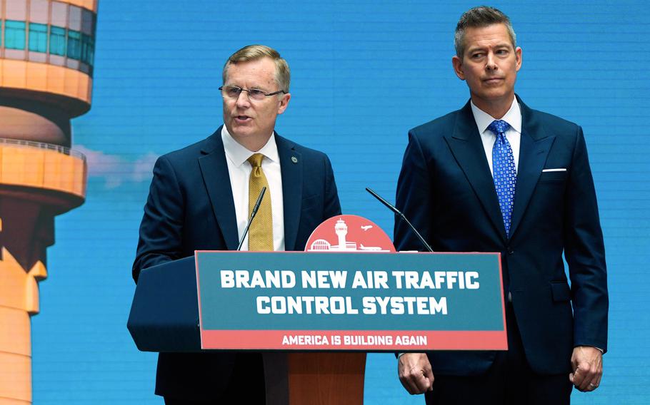 Rocheleau and Duffy speak at a lectern. On the lectern is a sign that says Brand New Air Traffic Control System.