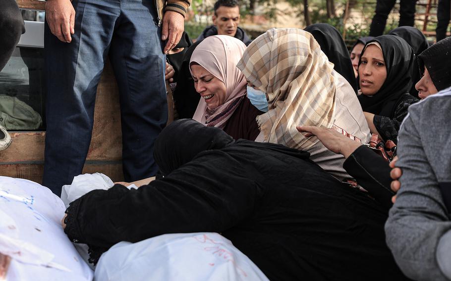 Palestinians mourn dead relatives outside a morgue in Khan Younis in southern Gaza on Nov. 19, 2023.