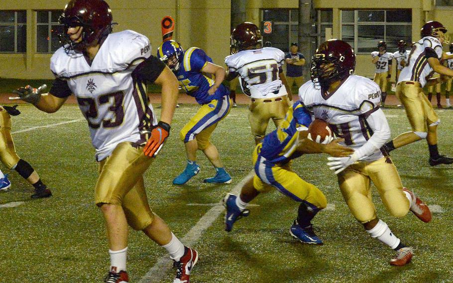 Matthew C. Perry's Denzel Gray gets an escort around left end from fullback Zeke Santoscoy.